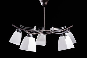 Modern lamp, chandelier on a black background. Lighting element of the interior. environmental materials of lamps