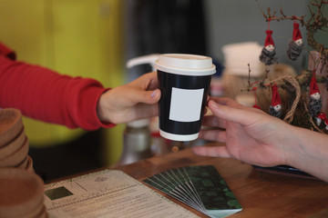 Fototapeta na wymiar barista giving take away hot coffee for customer in coffee shop.
