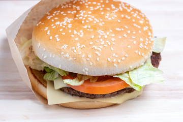 Burger in paper and on a light board