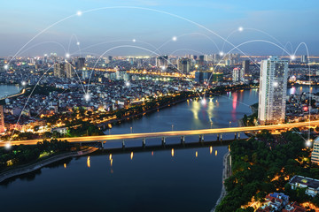 Fototapeta premium Smart city and wireless communication network concept. Digital network connection lines of Hanoi city, Vietnam at Linh Dam peninsula, Hoang Mai district
