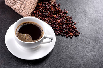 Preparation of aromatic morning coffee. Empty white coffee cup on a dark table