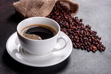 Preparation of aromatic morning coffee. Empty white coffee cup on a dark table