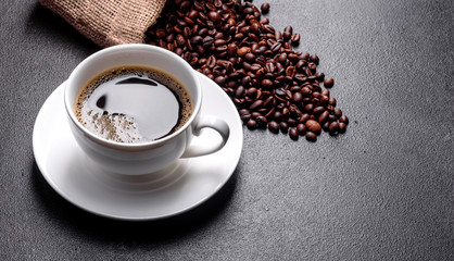 Preparation of aromatic morning coffee. Empty white coffee cup on a dark table