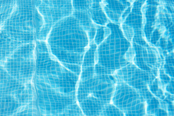 Photo of water in swimming pool, surface of blue pool, ripple vacuity in pool, sun reflection in basin, clear light blue pool water, top view of backwash in basin, rippled aqua detail background.