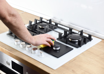 Removing dirt on the gas burner with a brush. Cleaning and maintenance of the cooking glass surface.Cleaning the gas grill and burner.