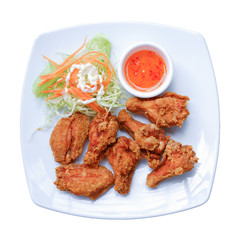 Chicken fired unhealthy food with spicy sauce on white plate