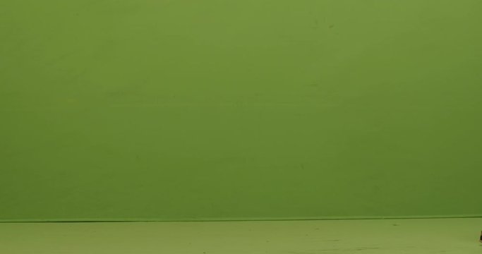 GREEN SCREEN FULL SHOT Caucasian male caughing while walking with suitcase
