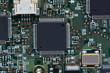 Close-up electronic circuit board with microchips resistors and connector