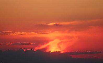 Fiery sunset, haze and clouds of a red tint.