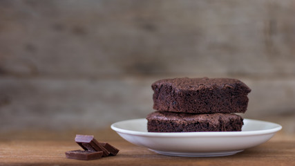 Chocolate brownies stacks on wooden background, homemade sweet and dessert