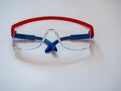 Pair of safety goggles on white background