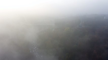 A city covered in fog. City traffic, aerial view