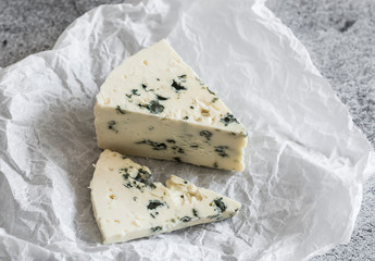 Piece of gorgonzola cheese on a grey background. Delicious food