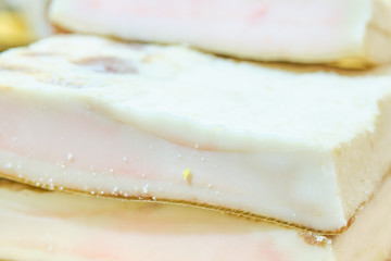 Slices of fat on a store counter.