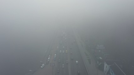 A city covered in fog. City traffic, aerial view