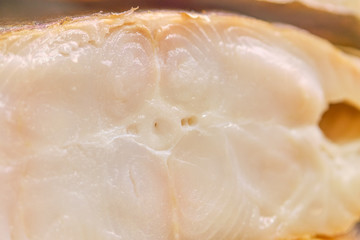 Obraz premium Smoked fish in a cut on a store counter.