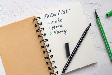 To do list - make more monTo do list - make more money written text on note pad. Close upe written...