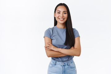 Lively, enthusiastic and determined smiling confident asian girl ready tackle any task, cross fingers over chest assertive, self-assured, smiling satisfied, look like professional, white background