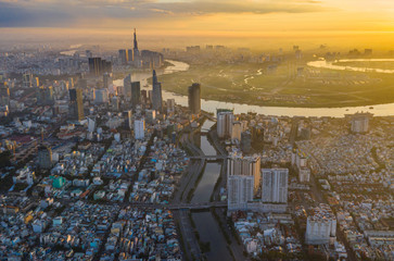 Aerial cityscape view of Saigon city with orange twilight sky