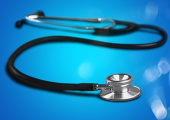 Classic medical stethoscope on the blue background