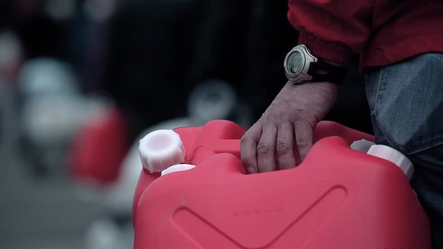 Queue of civil who wait for the distribution of drinkable water with close-up on an empty container, after the tsunami on March 11th 2011 near Fukushima