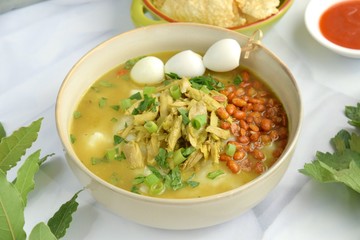 Bubur ayam, Indonesian chicken rice porridge or congee with shredded chicken, fried soy beans, boiled quail egg skewer, celery, scallion, krupuk and emping. 
