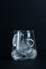Cold ice in glass black background