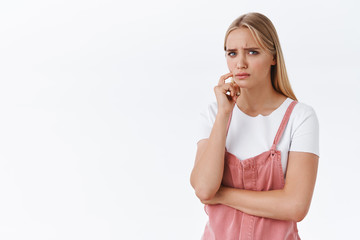 Girl feeling concern and doubts, thinking about something troublesome and upsetting, frowning suspicious stare skeptical with disbelief touch face, having uneasy feeling, something worry her