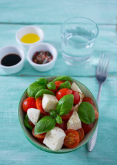 caprese salad on turquoise background