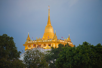 Naklejka premium Chedi of the Buddhist temple Wat Saket (Temple of the Golden Mountain) on evening twilight. Bangkok, Thailand
