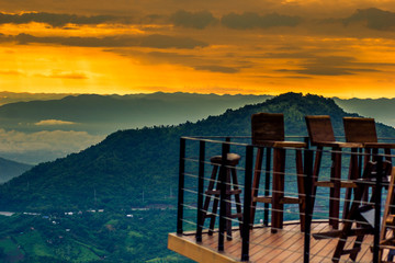 abstract background blur view of the sun shining through the clouds,surrounded by large mountains and various species of trees
