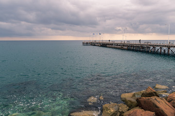 Fototapeta na wymiar A wooden pier at he waterfront of Limassol