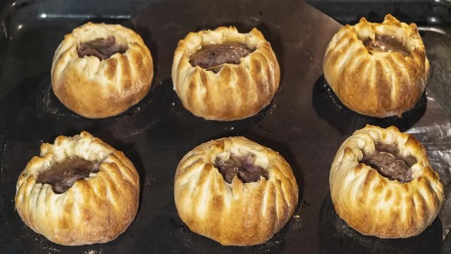 Cooking open meat pies in the oven, time lapse,