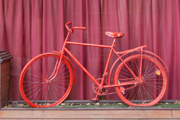 Naklejka na ściany i meble Red bicycle and a background of a fandango color.