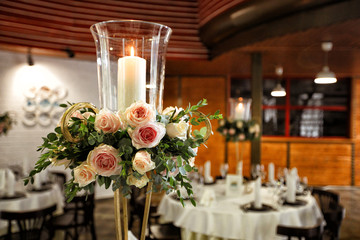 a candle with glass candlestick decorated flowers