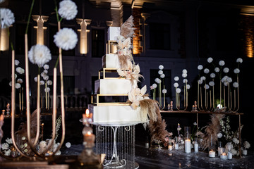 wedding decor. Unusual white tiered wedding cake.