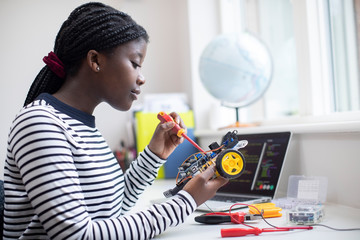 Female Teenage Pupil Building Robot Car In Science Lesson - obrazy, fototapety, plakaty