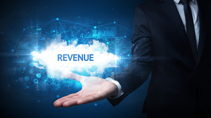 Hand of Businessman holding REVENUE inscription, successful business concept