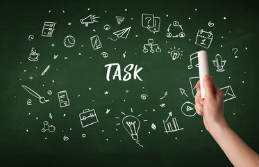 Hand drawing TASK inscription with white chalk on blackboard, education concept