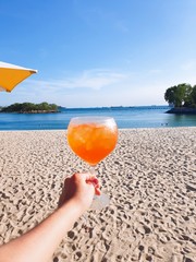 woman with cocktail on beach