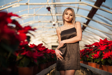 Portrait of a young fashion model in a sexy top at tropical garden.