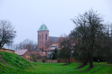 Former moat and Co-Cathedral of St. John the Baptist in background  in Kamien Pomorski, Poland