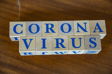 Wooden cubes with word Coronavirus in blue letters