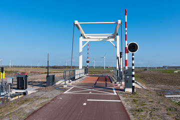 a cycle path with a bridge in the background on a sunny day. In Zeewolde Flevoland. March 7, 2020 the Netherlands.