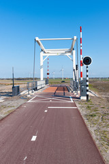 a cycle path with a bridge in the background on a sunny day. In Zeewolde Flevoland. March 7, 2020 the Netherlands.
