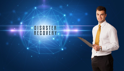 Businessman thinking about security solutions with DISASTER RECOVERY inscription