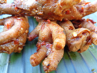 Spicy grilled quail's egg (telur bakar pedas) on banana leaves. Indonesian cuisine street food.