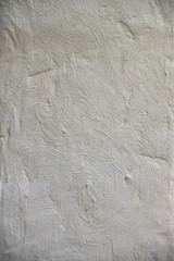Roughly treated white putty wall with furrows. Texture wallpaper.