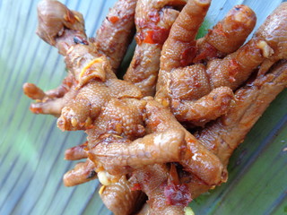 Spicy grilled quail's egg (telur bakar pedas) on banana leaves. Indonesian cuisine street food.