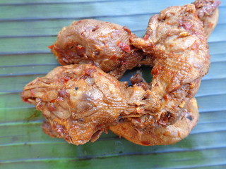 Spicy grilled quail's egg (telur bakar pedas) on banana leaves. Indonesian cuisine street food.